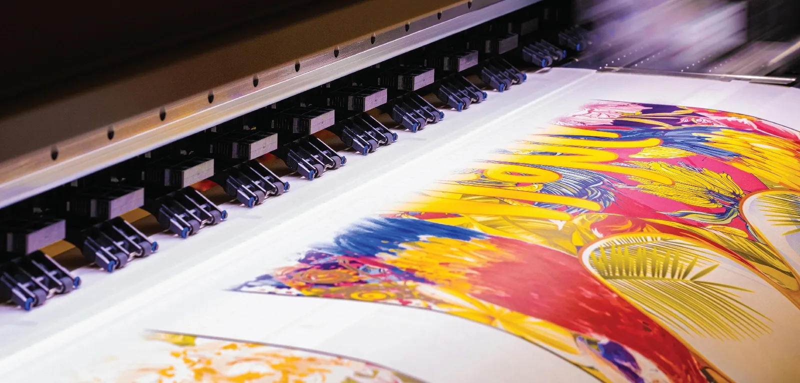 A colorful design exits a printer