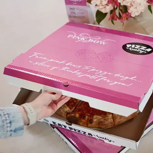 Pizza in a pink box that says 